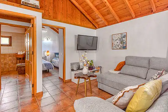 Villa Atardecer – Salón con televisión y acceso a los dormitorios
